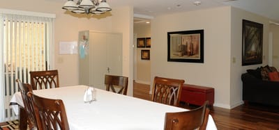 Bright common area with dining table and seating.
