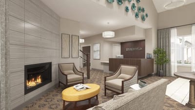 Bright communal lounge area with seating and fireplace