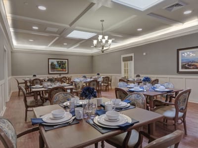 Elegant dining room set with dishes and floral centerpieces