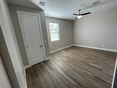 Bright interior room with wooden flooring and window