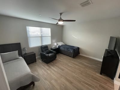 Private resident room with bed and comfortable seating