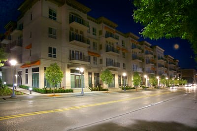 Exterior view of a modern assisted living facility at night