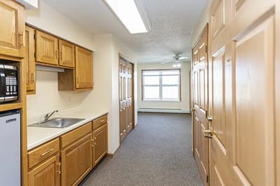 Interior view of a private resident room with kitchen