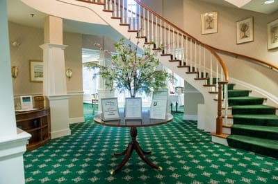Elegant interior lobby with staircase and floral decorations