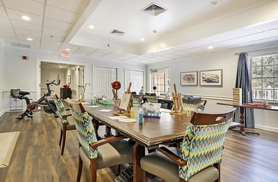 Bright common area with art supplies and exercise equipment