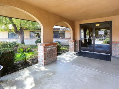 Entrance with arched architecture and garden view