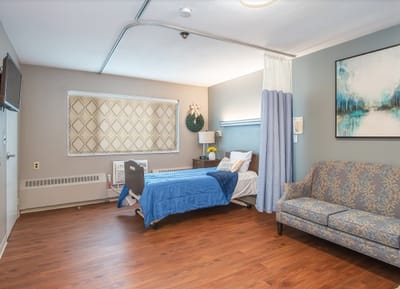Cozy resident room with a bed and seating area