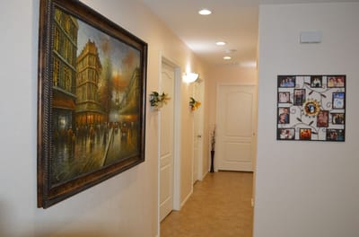 Interior hallway with framed artwork and photos
