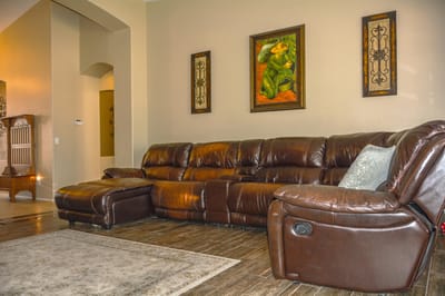 Cozy common area featuring a leather sectional sofa