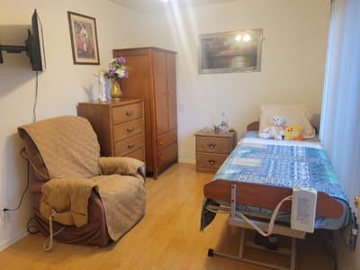 Cozy resident room with a bed and a chair