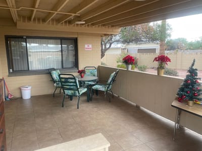 Outdoor seating area with chairs and flowers
