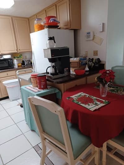 A small kitchen setup with coffee maker and snacks