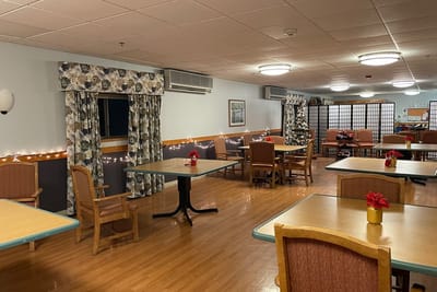 Interior of a cozy dining area with tables and decorations