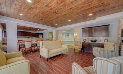 Bright common area with comfortable seating and wooden ceiling