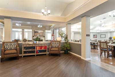 Interior view of a common area with residents and furnishings