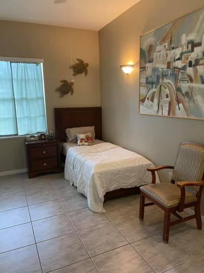 Cozy private resident room with bed and chair