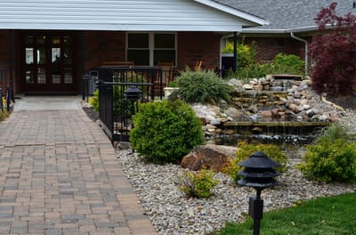Pathway leading to a serene garden with water feature