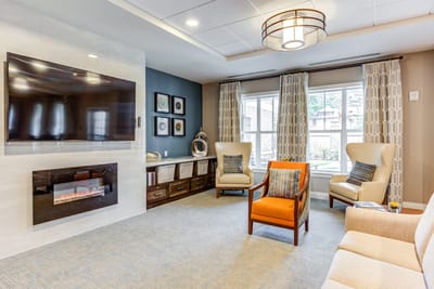 Bright common area with seating and fireplace