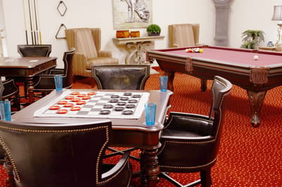 Interior communal games area with billiards and checkers table