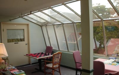 Bright common area with large windows and seating