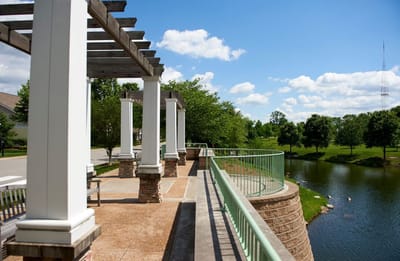 Outdoor view of a scenic patio overlooking a pond