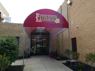 Entrance of Bethlehem Manor with awning and signage