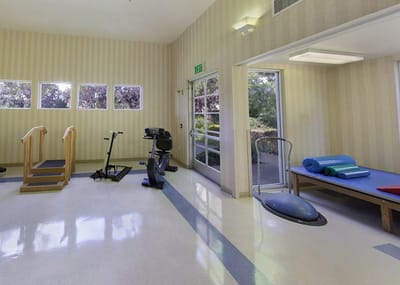 Interior of a fitness area with equipment and mats