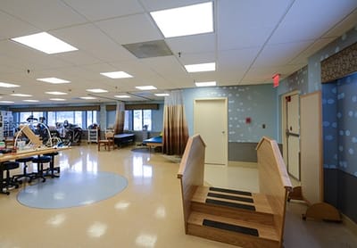 Bright rehabilitation room with therapy equipment
