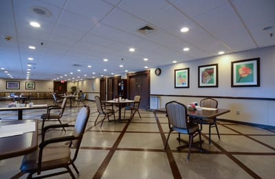 Interior view of a common area with tables and artwork