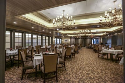 Elegant dining room setup with chandeliers and tables