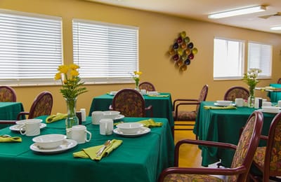 Bright dining room with tables set for a meal