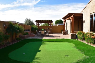 Outdoor patio area with putting green and seating
