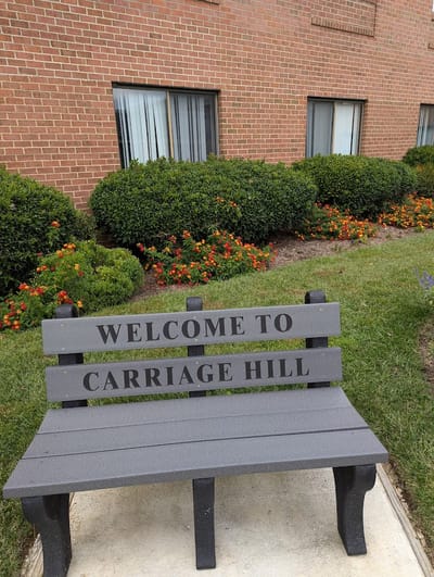 Welcome bench outside Carriage Hill of Bethesda