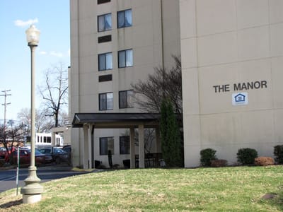 Exterior view of The Manor building entrance
