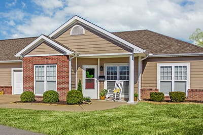 Exterior view of a senior living facility with landscaped entrance