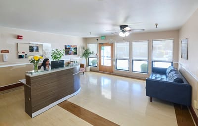 Reception area with a staff member at the front desk