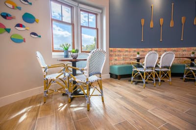 Bright common area with decorative seating and wall art