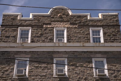 Exterior view of a historic building with text signage