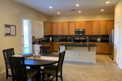 Modern kitchen area with dining table and appliances