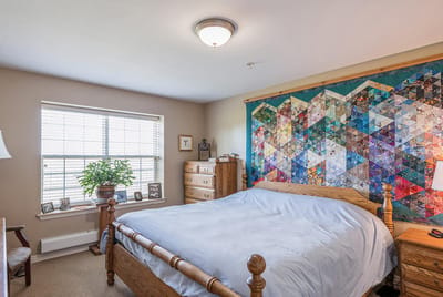 Cozy private resident room with quilt and decor