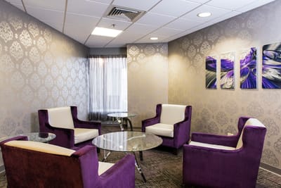 Interior lounge area with purple chairs and modern decor