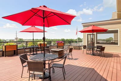 Outdoor seating area with red umbrellas and views