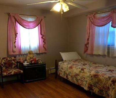 Cozy bedroom with floral bedding and curtains