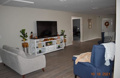Bright common area with seating and television