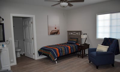 Private resident room with a bed and seating area