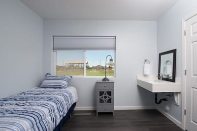 A private resident room with a bed and window