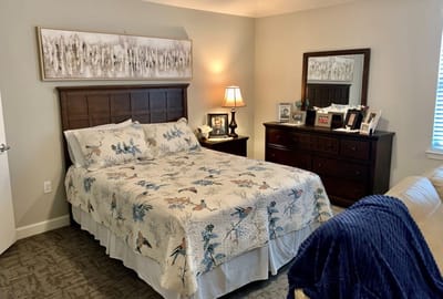 Cozy bedroom with a floral comforter and personal touches