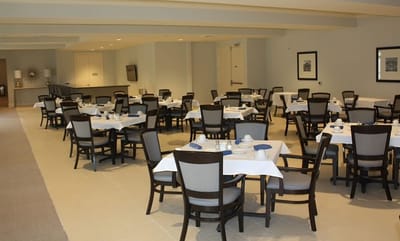 Dining room with tables set for residents