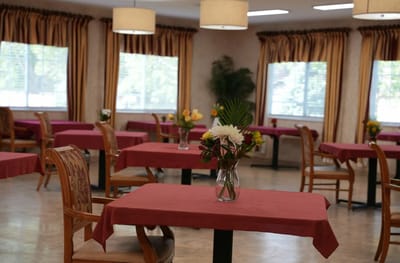 Dining area with tables and floral arrangements