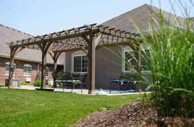 Outdoor seating area with pergola and grass